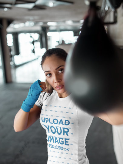 Woman Striking the Pear at the Gym While Wearing Custom Sportswear Mockup