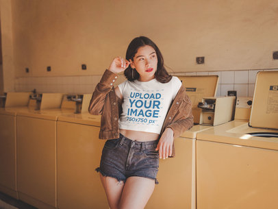 Woman Wearing a Crop Top Tee Mockup Leaning Against a Washing Machine