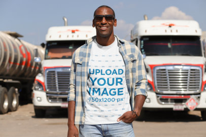 T-Shirt Mockup of a Truck Driver Posing in Front of Two Trucks 29460