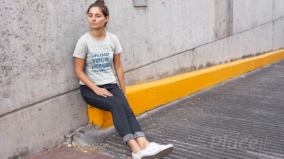 T-Shirt Video of a Woman Sitting By a Parking Lot Ramp